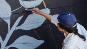 Femme qui peint une fresque murale